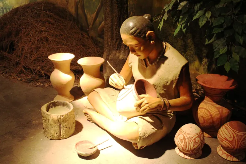 A diorama of a lady painting pots at the Ban Chiang Museum, Thailand.